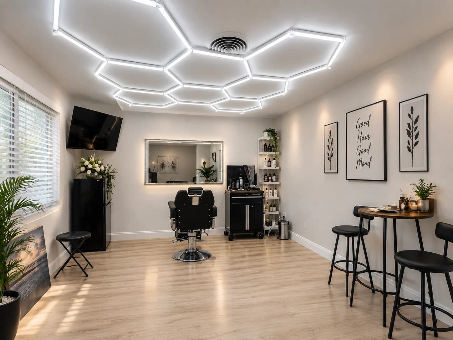 Burce Sume Hair Studio in Clearwater, with a single styling chair, illuminated mirror, and warm wood floor.